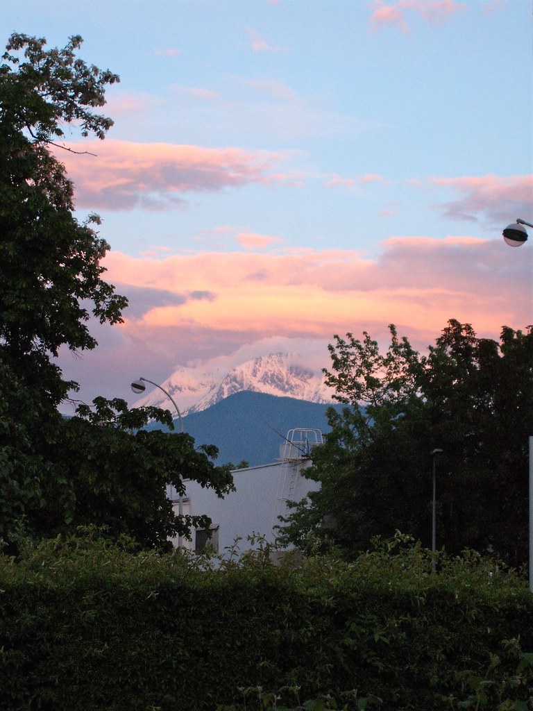 Sunset pink clouds atop mountains